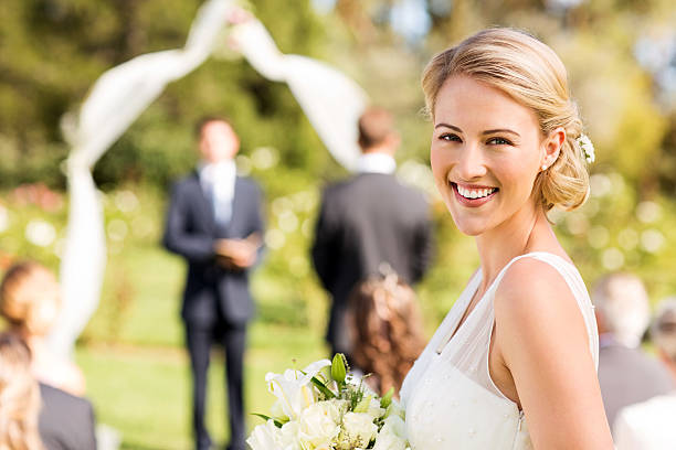 istock Bride Smiling During Wedding Ceremony In Garden 187360615