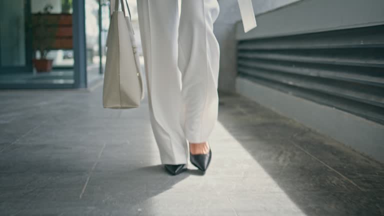 Stylish woman legs walking office in high heels closeup. Girl feet going on work