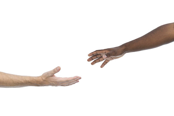 Interracial assistance Caucasian and african hands reaching each other on white background aluxum stock pictures, royalty-free photos & images