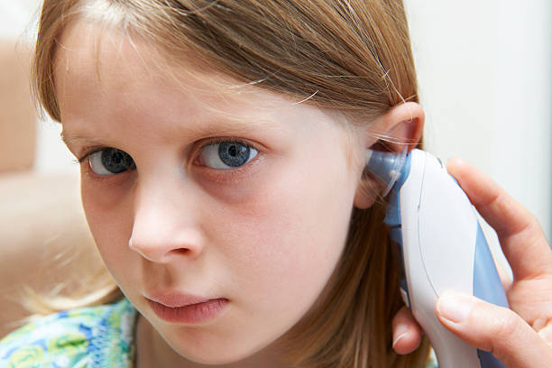 istock Young Girl Having Temperature Taken With Digital Thermometer 187362947