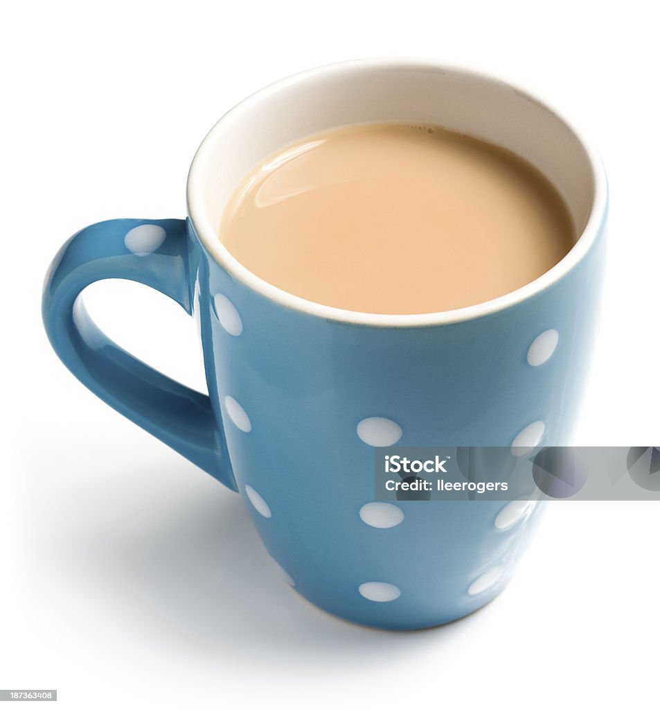 A blue and white polka dot colored cup of tea English breakfast tea with a splash of milk in a blue mug with spots isolated on a white background. English breakfast tea is a black tea used to make aromatic beverage. The drink is prepared by pouring boiling water over a tea bag or tea leaves which is left to brew. Tea with milk and sugar is also known as builders tea, a cuppa or a brew. Tea - Hot Drink Stock Photo