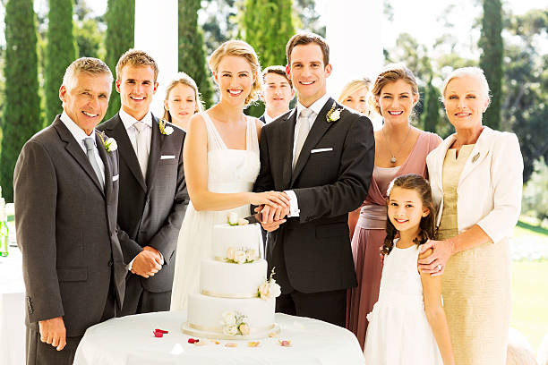 花嫁と花婿に立つお客様のウェディングケーキをカット - wedding cake newlywed wedding cake ストックフォトと画像