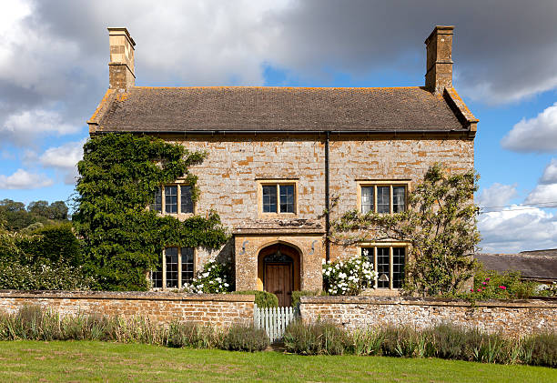 Cotswold farmhouse Pretty Cotswold stone farmhouse, Gloucestershire, England. walled garden stock pictures, royalty-free photos & images