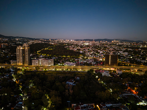 Mexico City skyline before dawn, with elevated roads and view of the will west of the city.