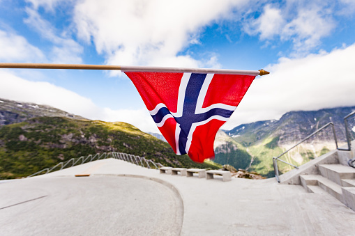 Man with the English flag on the background of the sea and mountains