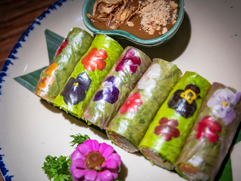 Fresh Vietnamese spring rolls wrapped with fresh flowers and vegetables.