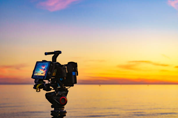istock Camera taking picture of sunset over sea 1873707991