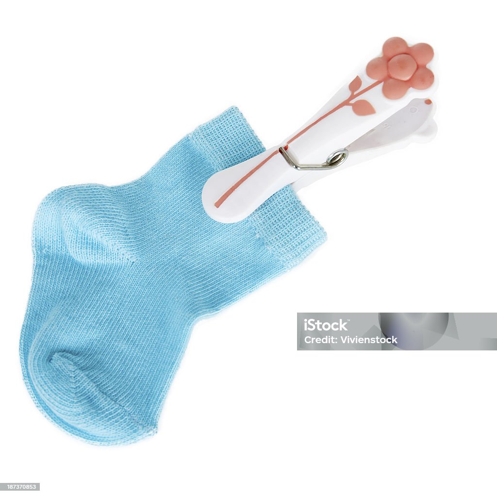 sock on a clothespin sock on a clothespin on a white background in studio Baby - Human Age Stock Photo