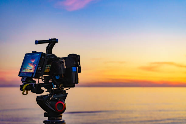 istock Camera taking picture of sunset over sea 1873709023