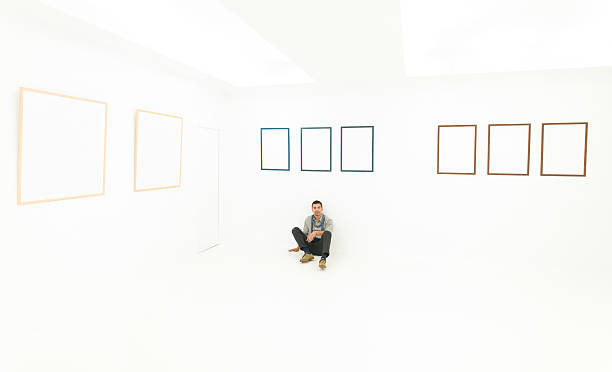 istock relaxed man sitting on a floor in art gallery 187370972