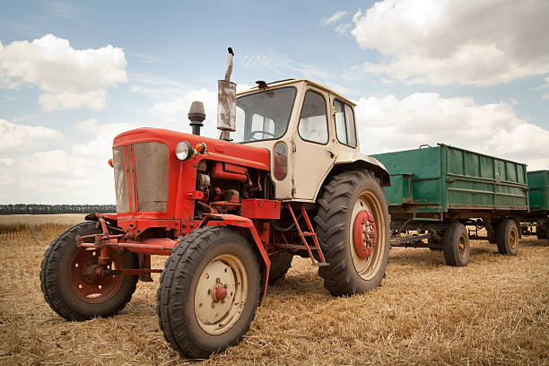 istock old tractor in field, against a cloudy sky 187371080