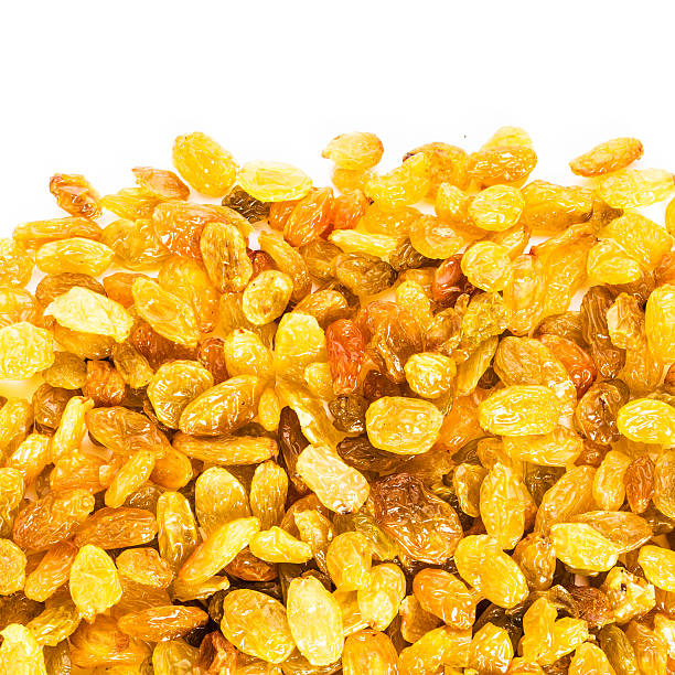 Yellow Golden Shiny Raisins isolated on white background.