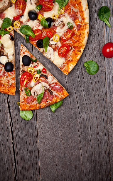 istock Italian pizza with slice cut out on wooden table 187371396