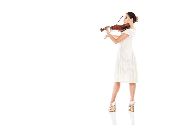 istock Beautiful young woman playing violin over white 187371414