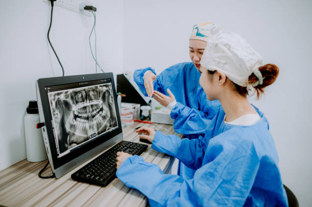 istock Two Asian Chinese dentists talking in the dental office. 1873715793
