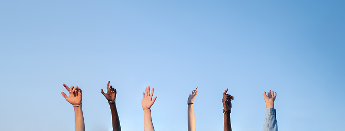 People arms raised up isolated on a blue background - Person hands.