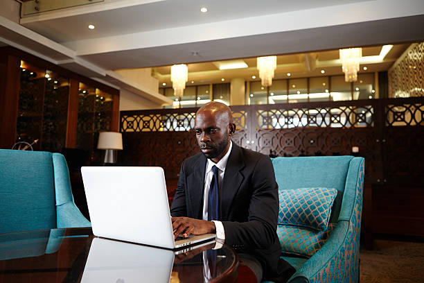 istock Black business man working late at the hotel lounge 187373434