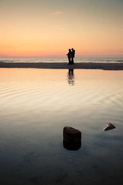 istock tourists walking on the beach 187373898