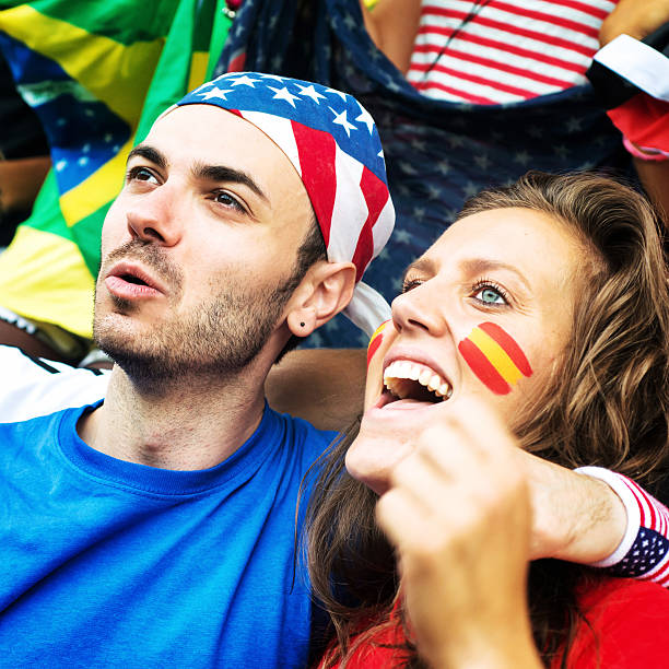 istock Supporters. German and American Fans embraced in foreground 187375953