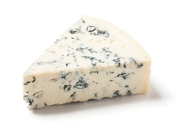 A wedge of gorgonzola, a type of bleu cheese, on white.