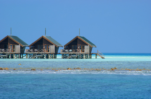 Maldivian water bungalow in the blue lagoon.