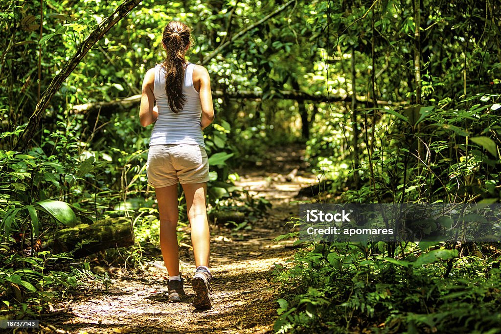 Young woman hiking on a tropical rainforest trail Amazon Rainforest Stock Photo