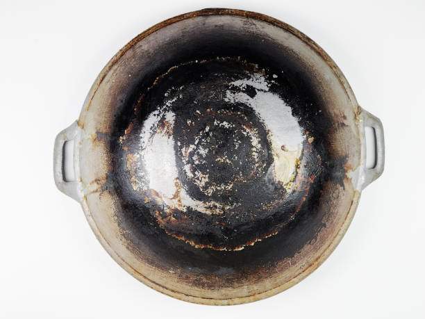 istock Charred frying pan isolated on white background, a testament to culinary mishaps 1873805111