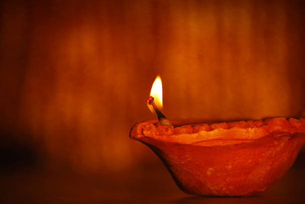 Diyas - Concept of celebration.Focus on thread and wick of diya. High depth of field. Slight soft focus.