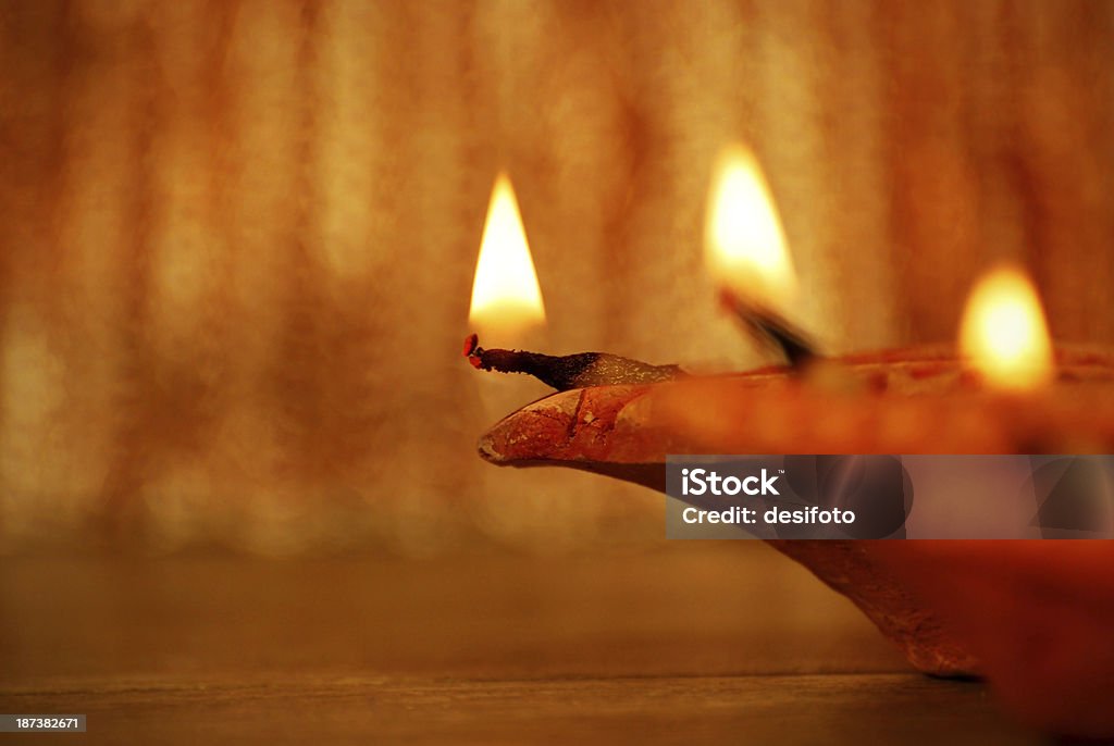 Diyas - Concept of celebration Diyas - Concept of celebration.Focus on thread and wick of left most diya. High depth of field. Antique Stock Photo