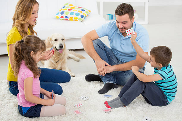 istock Cheerful Family Playing Cards. 187386076