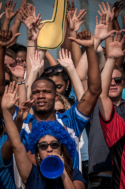 istock Fans with raised arms cheering for their team 187386506