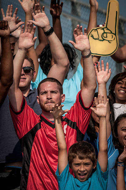istock Fans with raised arms cheering for their team 187386508