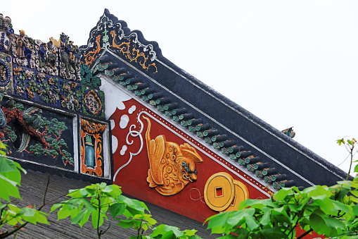 Guangzhou City, China - April 4, 2019: Beautiful colored sculptures on the roof, in an ancient ancestral hall, Guangzhou City, Guangdong Province, China