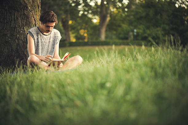 istock Young Men Reading Book at the Park 187388487