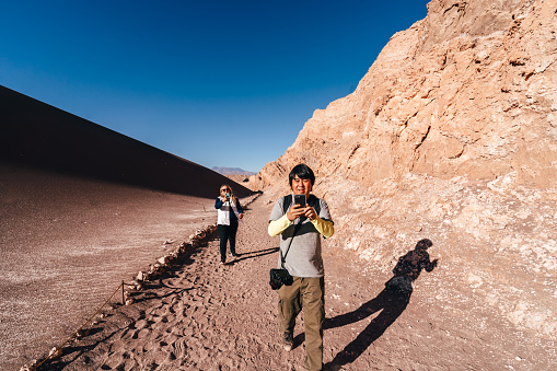 Friends vlogging on a trail in the Atacama Desert