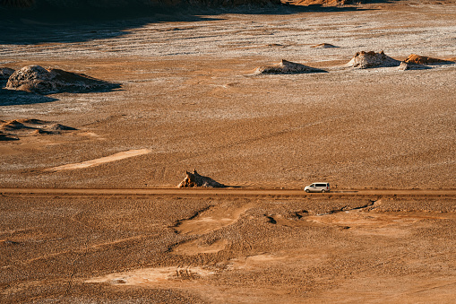 Car crossing the vastness of the Atacama Desert