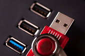 red plastic USB Stick lying on computer