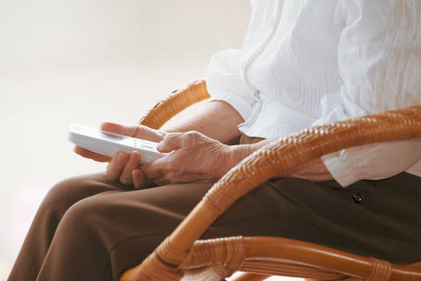 istock Elderly woman holding a phone in her hand 1873945292