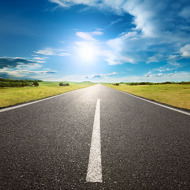 istock Driving on empty road towards the sun 187394956