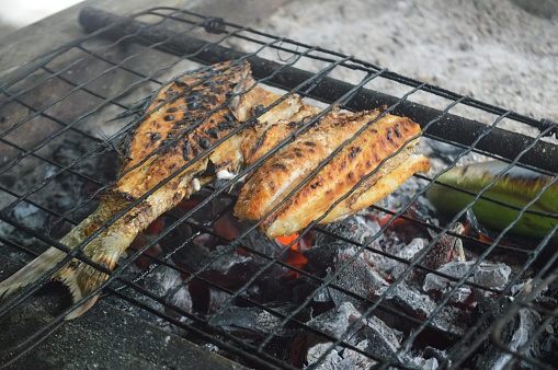 grilled fish, sea fish grilled over a charcoal fire on the beach, Indonesian seafood barbeque