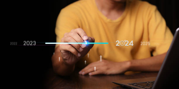 istock Countdown to 2024 concept. the taps a virtual download bar with a loading progress meter on New Year's Eve, turning the year 2023 to 2024. 1873972375