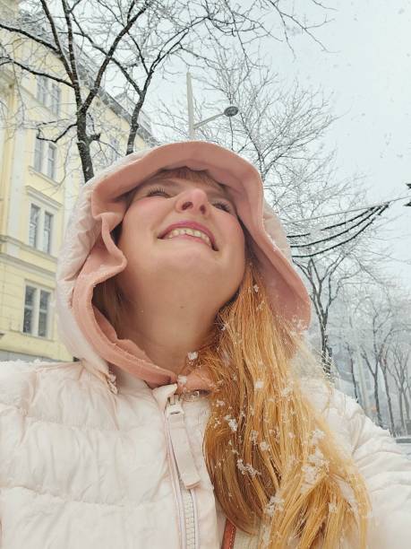 istock Portrait positive middle-aged woman enjoying snowfall 1873973161