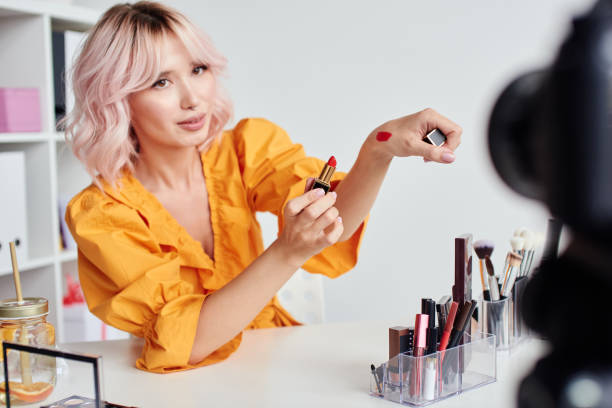 istock Pretty woman testing cosmetic product in front of camera 1874001605