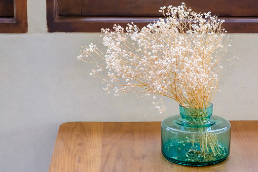 Caspia dried flowers in the glass vase decorated on the wooden table in the house
