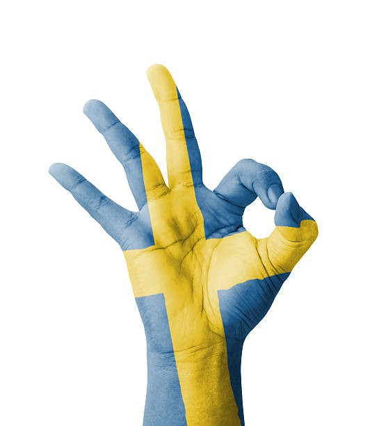 Hand making Ok sign, Sweden flag painted stock photo