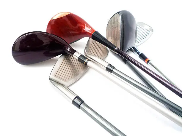 Six different golf clubs on white background.
