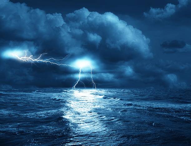 istock Lightning strikes the ocean on a stormy sea 187405572