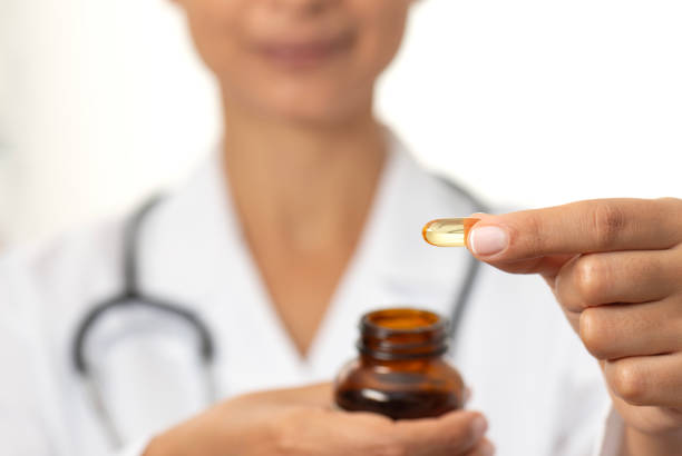 istock Female Doctor Showing Soft Gel Capsule 1874078193