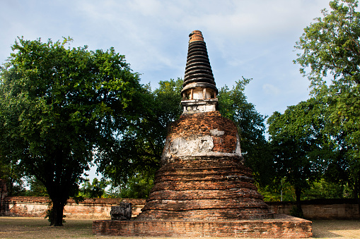 Ancient ruins ubosot ordination hall and antique old ruin stupa chedi for thai people traveler travel visit respect myth mystical in Wat Maheyong temple at Historic Heritage site in Ayutthaya Thailand