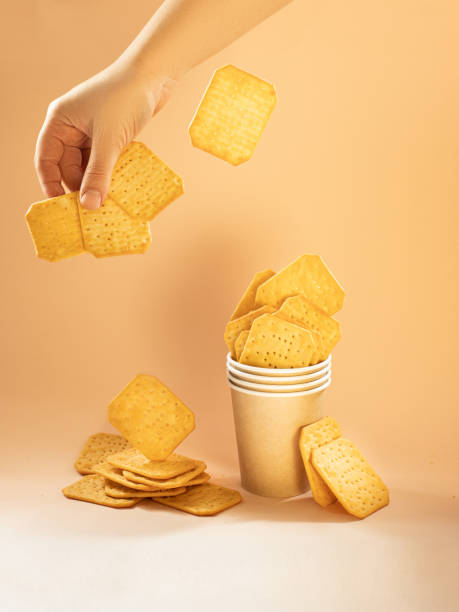 istock crackers in a glass on a yellow background 1874090720